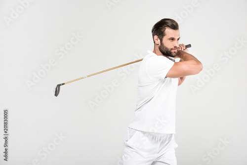 male golfer in white sportswear with golf club, isolated on grey