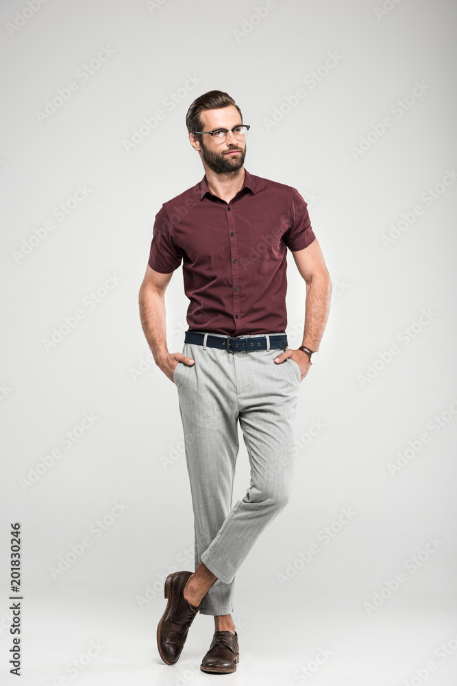 handsome stylish man posing in casual closing and eyeglasses, isolated on grey handsome stylish man posing in casual closing and eyeglasses, isolated on grey