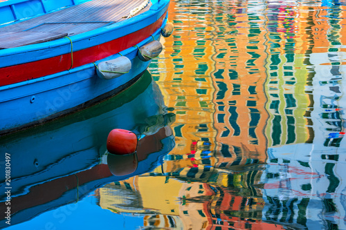 Boat and coloeful reflection on the water. photo