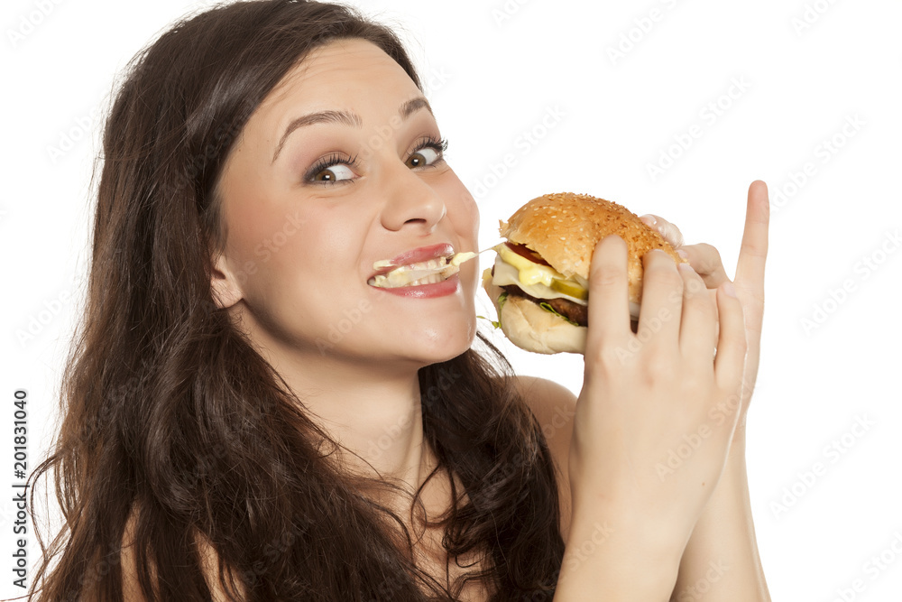 young stuffed greedy woman eating a hamburger on white background young stuffed greedy woman eating a hamburger on white background