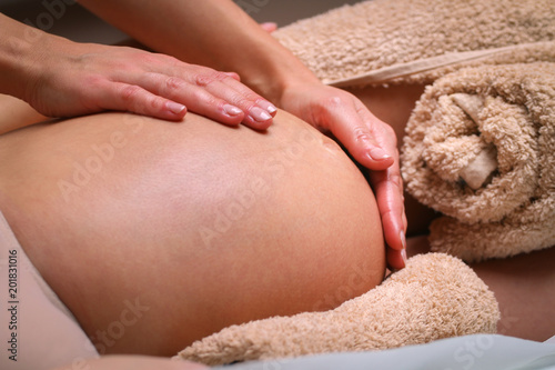 Massage therapist massaging pregnant woman