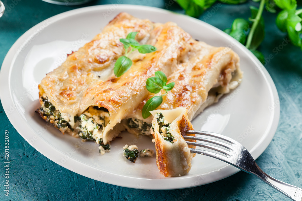 Portion of cannelloni stuffed with spinach Portion of cannelloni stuffed with spinach