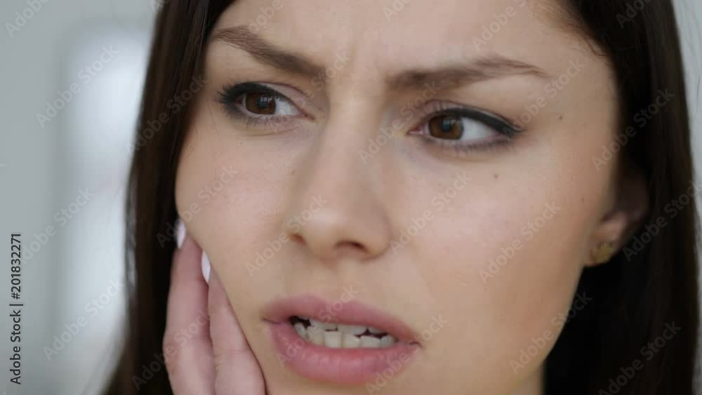 Close Up of Toothache Gesture by Young Woman, Face Close Up of Toothache Gesture by Young Woman, Face