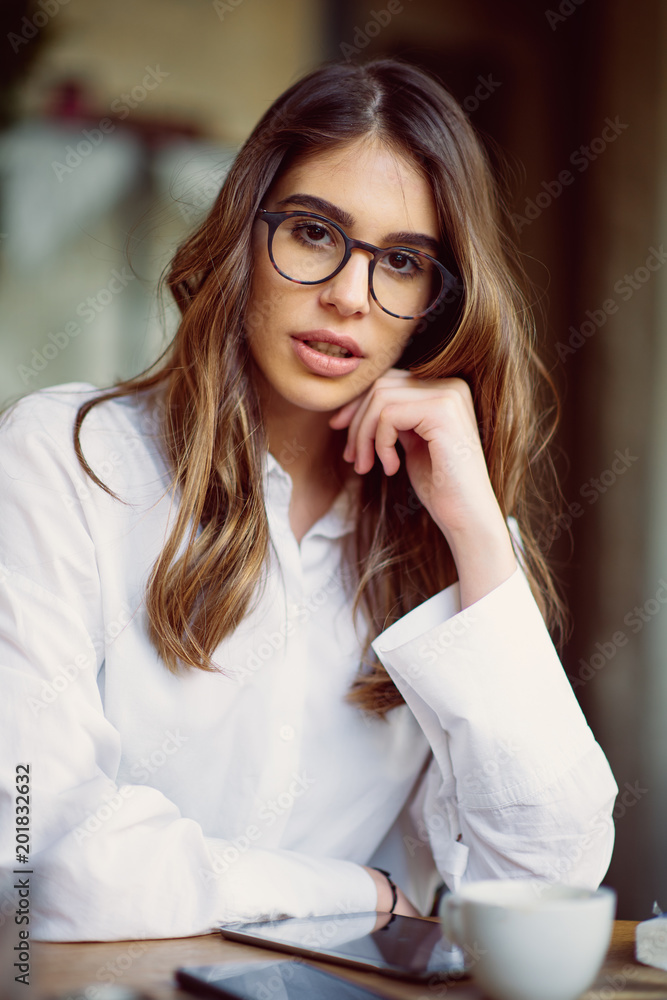 Young modern woman sitting in cafe. Young modern woman sitting in cafe.