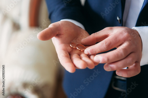 Wedding rings in grooms hands