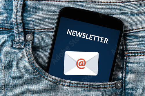 Subscribe newsletter concept on smartphone screen in jeans pocket. All screen content is designed by me. Flat lay