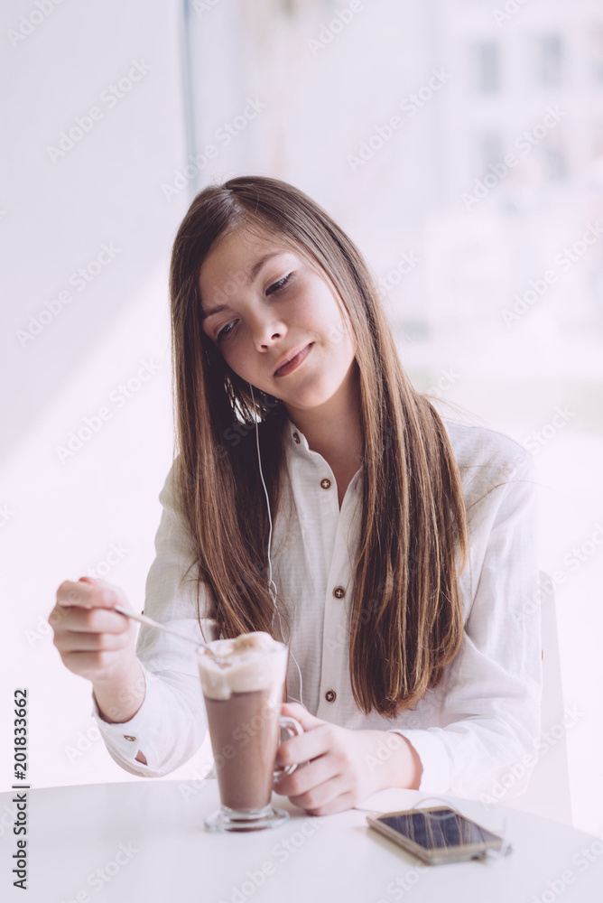 Beautiful brunette drinking coffee on summer terrace Beautiful brunette drinking coffee on summer terrace