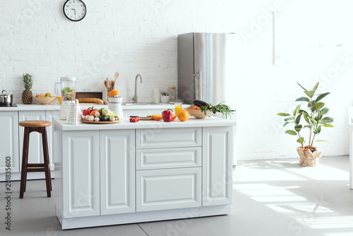 Fototapeta Naklejka Na Ścianę i Meble -  interior of white light kitchen with fruits and vegetables on kitchen counter