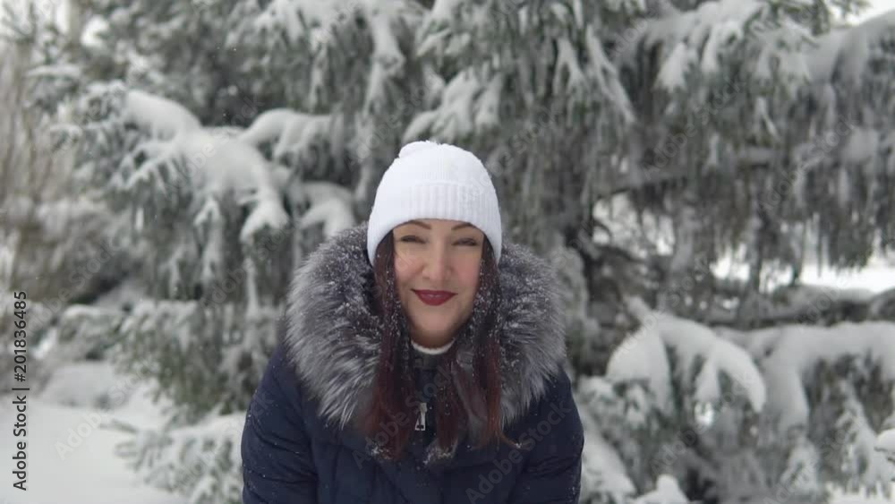 Happy girl throw up snow in winter forest, slow motion Happy girl throw up snow in winter forest, slow motion