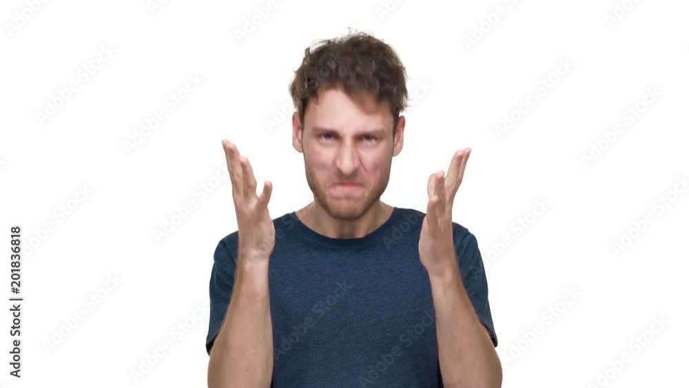Portrait of irritated guy in t-shirt gesturing and shouting in anger and stress, isolated over white background. Concept of emotions Portrait of irritated guy in t-shirt gesturing and shouting in anger and stress, isolated over white background. Concept of emotions