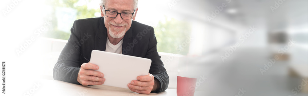 Portrait of senior businessman working on tablet Portrait of senior businessman working on tablet