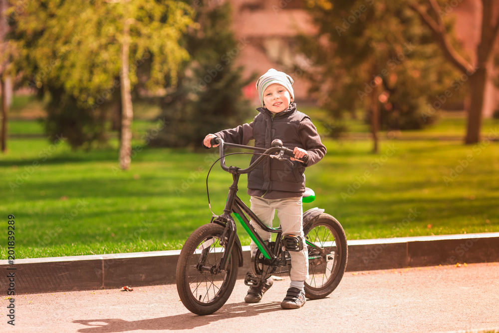 Happy little boy riding a bike Happy little boy riding a bike