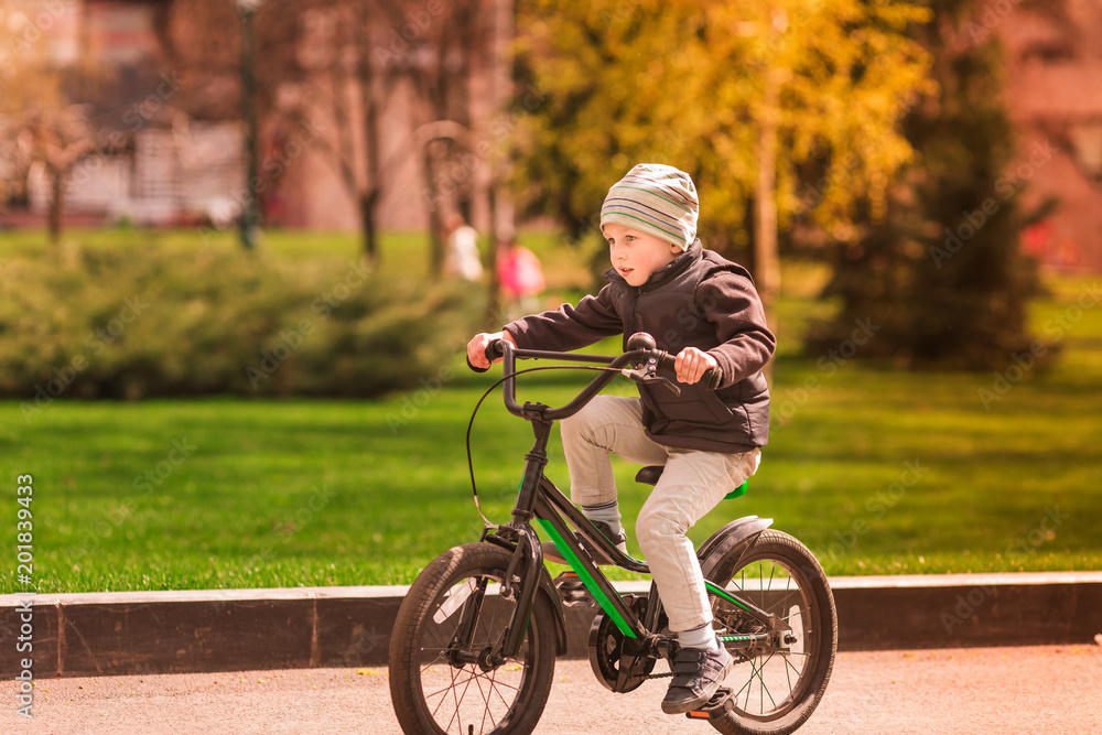 Happy little boy riding a bike Happy little boy riding a bike