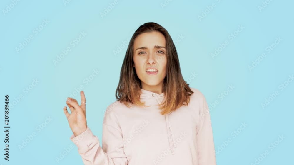 Serious and mad young ppretty beautiful woman or student, sways her finger in disapproval and disappointment, says no with gestures and face expression, no way movement, not happening Serious and mad young ppretty beautiful woman or student, sways her finger in disapproval and disappointment, says no with gestures and face expression, no way movement, not happening
