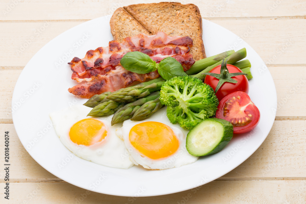 Fried eggs with bacon on the wooden table. Fried eggs with bacon on the wooden table.