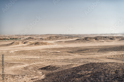 Desert landscape on clear blue sky background. Dune land with dry terrain surface. Ecology and global warming effect. Hopelessness and lifeless concept, copy space