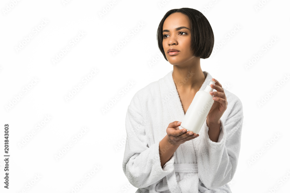 african american woman in bathrobe holding bottle of lotion, isolated on white african american woman in bathrobe holding bottle of lotion, isolated on white