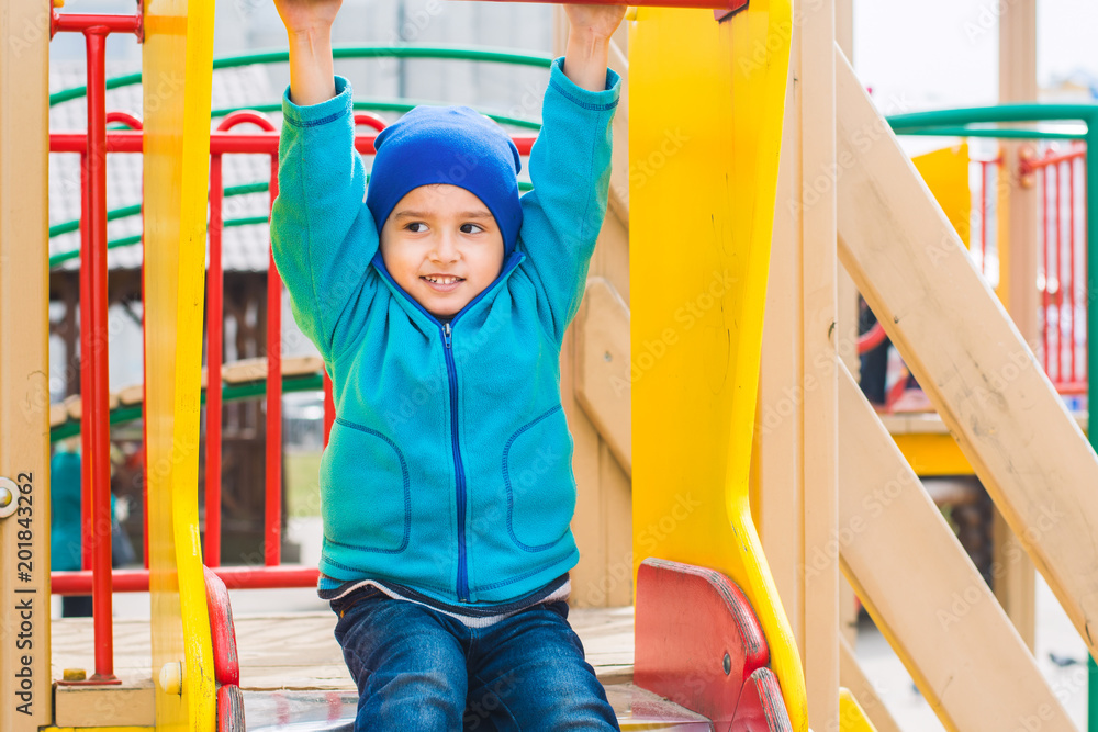 Fototapeta premium boy plays on the Playground