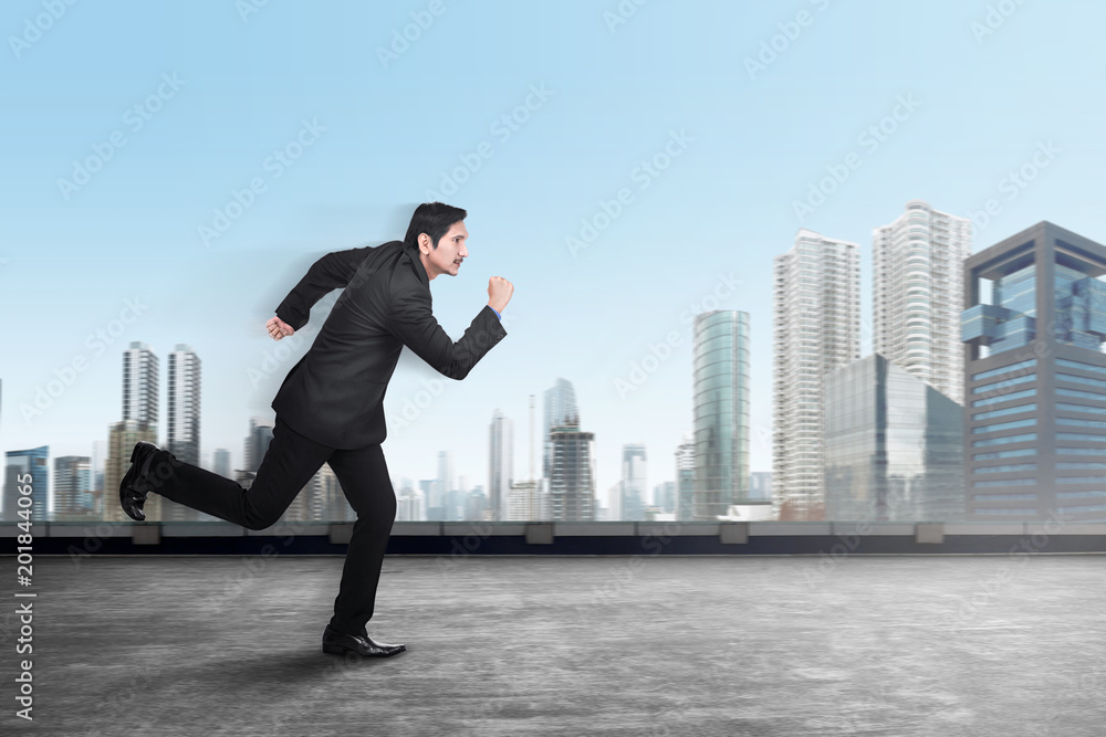 Handsome asian businessman running to office