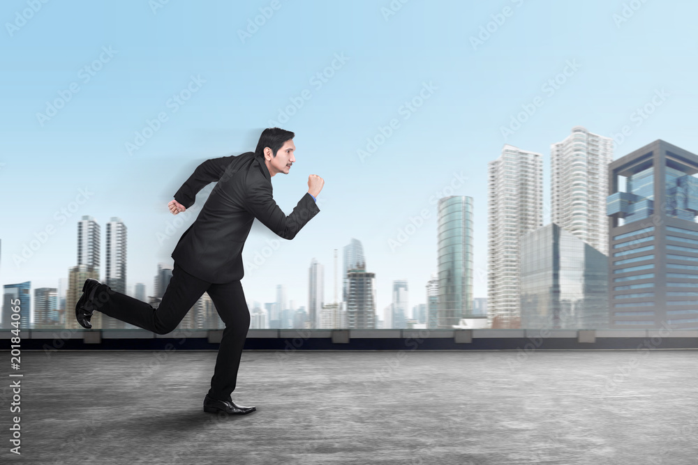 Handsome asian businessman running to office Handsome asian businessman running to office