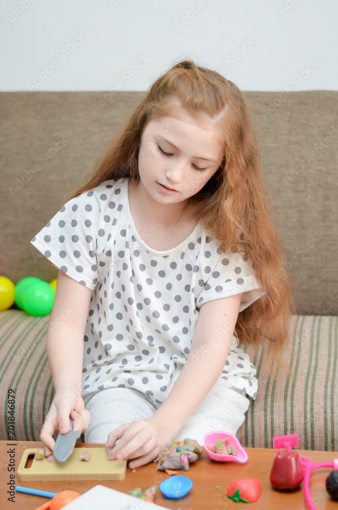 Lovely child girl playing dough and painting with pastel in the living room. Lovely child girl playing dough and painting with pastel in the living room.