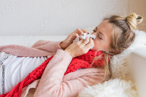Sick woman with tissue and running nose