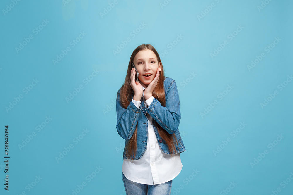 Beautiful teen girl looking suprised isolated on blue Beautiful teen girl looking suprised isolated on blue