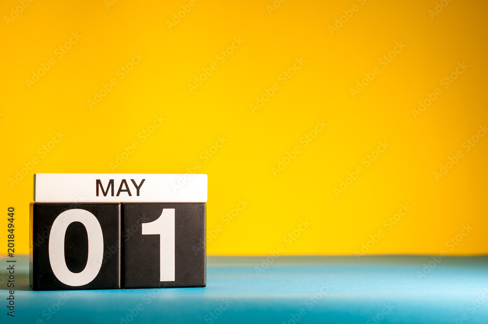 May 1st. Day 1 of may month, calendar on yellow background. Spring time, International labor day - obrazy, fototapety, plakaty 