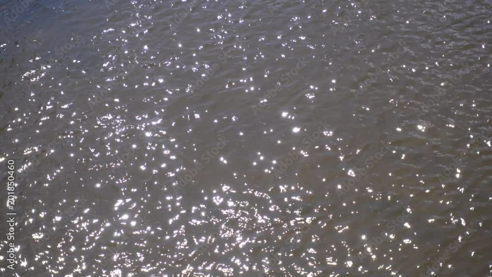 Abstract background with blurred water surface and bright reflection of sunset light. Abstract background with blurred water surface and bright reflection of sunset light.