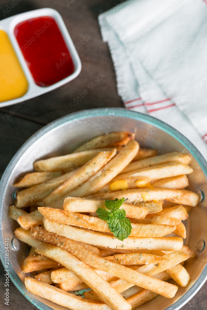 French fries on pan with tomato sauce and cheese sauce. French fries on pan with tomato sauce and cheese sauce.