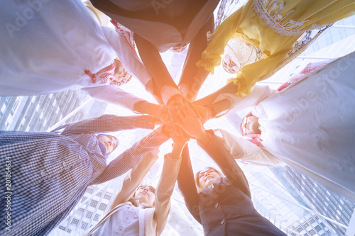 Underneath view of business people hands together concept.