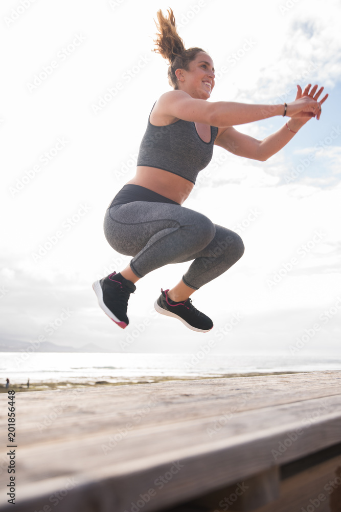 Pretty young woman jumping on stairs Pretty young woman jumping on stairs