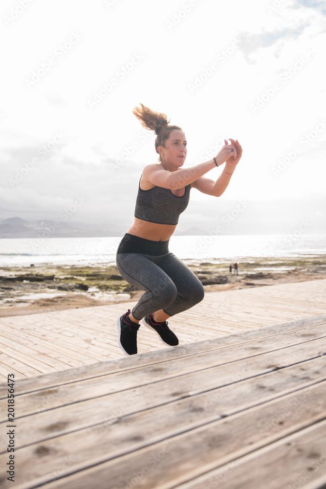 Fototapeta premium Sporty young woman doing fitness training
