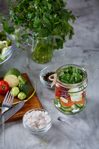 Fresh vegetable salad and ripe veggies on cutting board over white background, close up, selective focus