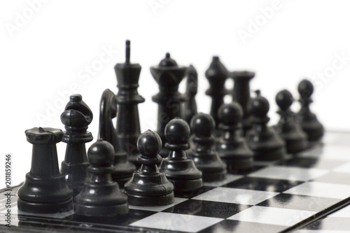 Plastic black chess on a chessboard