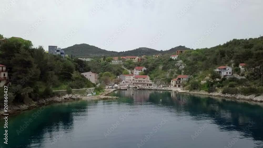 Aerial: Flying up in front of small beautiful blue green bay lagoon. Filmed while sailing in Croatia on islan Dugi otok behind village Sali at beautiful blue Adriatic sea. Aerial: Flying up in front of small beautiful blue green bay lagoon. Filmed while sailing in Croatia on islan Dugi otok behind village Sali at beautiful blue Adriatic sea.
