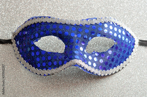 A blue mask on a silver background