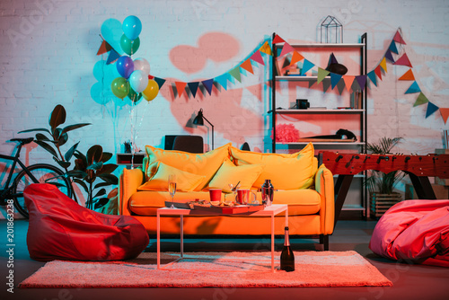 Interior of cozy room decorated with balloons for party photo