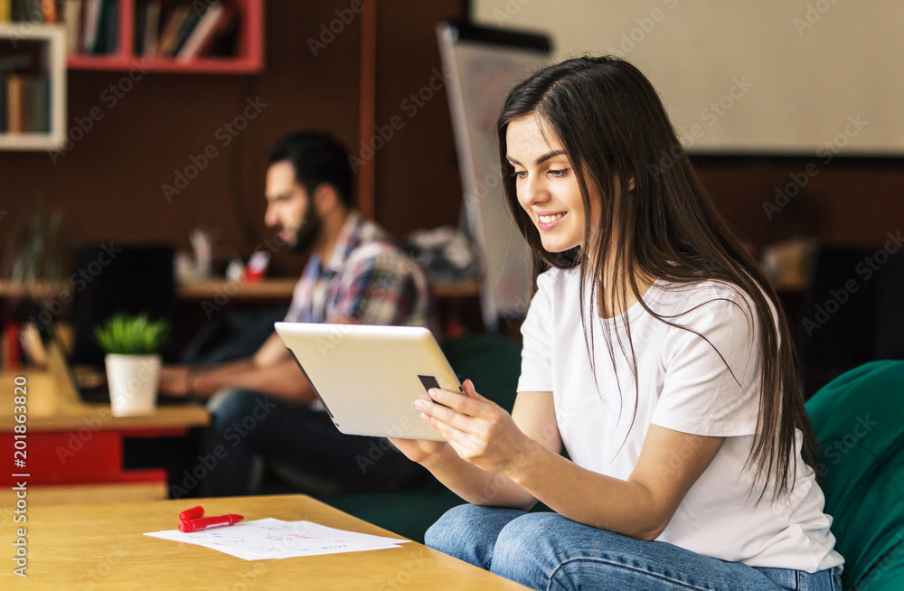 Young girl enterpreneur work with tablet in modern office Young girl enterpreneur work with tablet in modern office
