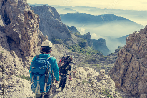 Fényképezés Pair of mountaineers walking a mountain path.