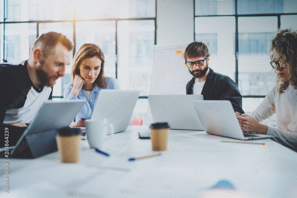 Brainstorming process at office.Young coworkers working together modern meeting room.Horizontal.Blurred background. Brainstorming process at office.Young coworkers working together modern meeting room.Horizontal.Blurred background.