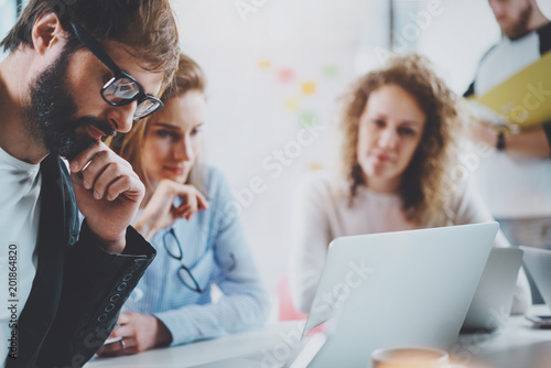 Closeup view Business team making conversation at sunny meeting room.Horizontal.Blurred background.