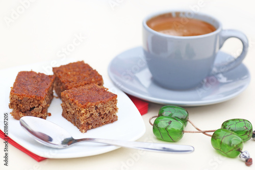 traditional greek coffee with pecan pie dessert and green rosary on the table