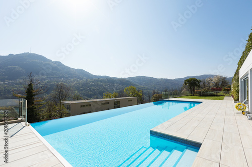 Exterior of building with swimming pool overlooking the hills