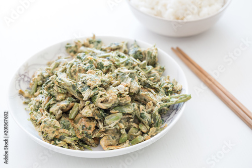 Delicious Chinese meal, Chinese food, Scrambled Eggs with Toona sinensis. Rice and chopsticks photo