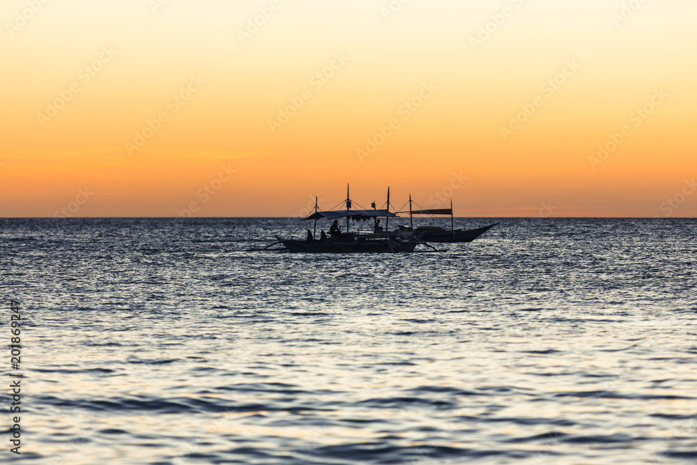Two fishing boats on the horizon