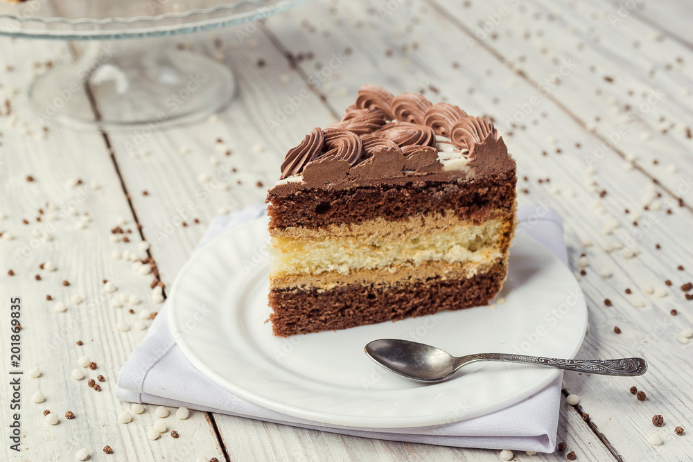 dark chocolate vegan cake with cream and caramel on wooden background dark chocolate vegan cake with cream and caramel on wooden background