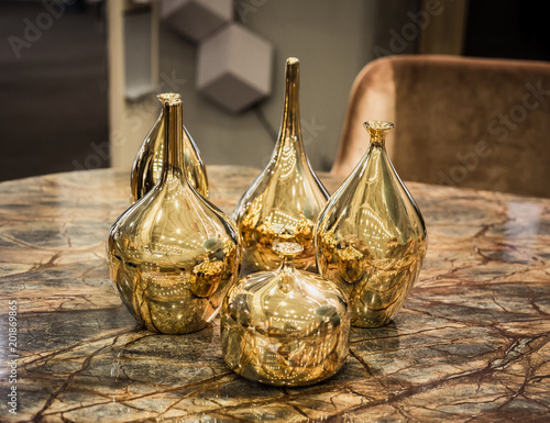 Four beautiful glossy golden vases - perfect luxirious interior element photo
