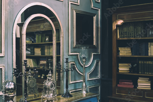 luxury and expensive interior with royal furniture, old books and silver design elements