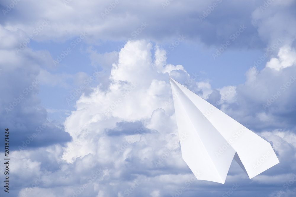 White paper airplane in a blue sky with clouds. The message symbol in the messenger White paper airplane in a blue sky with clouds. The message symbol in the messenger